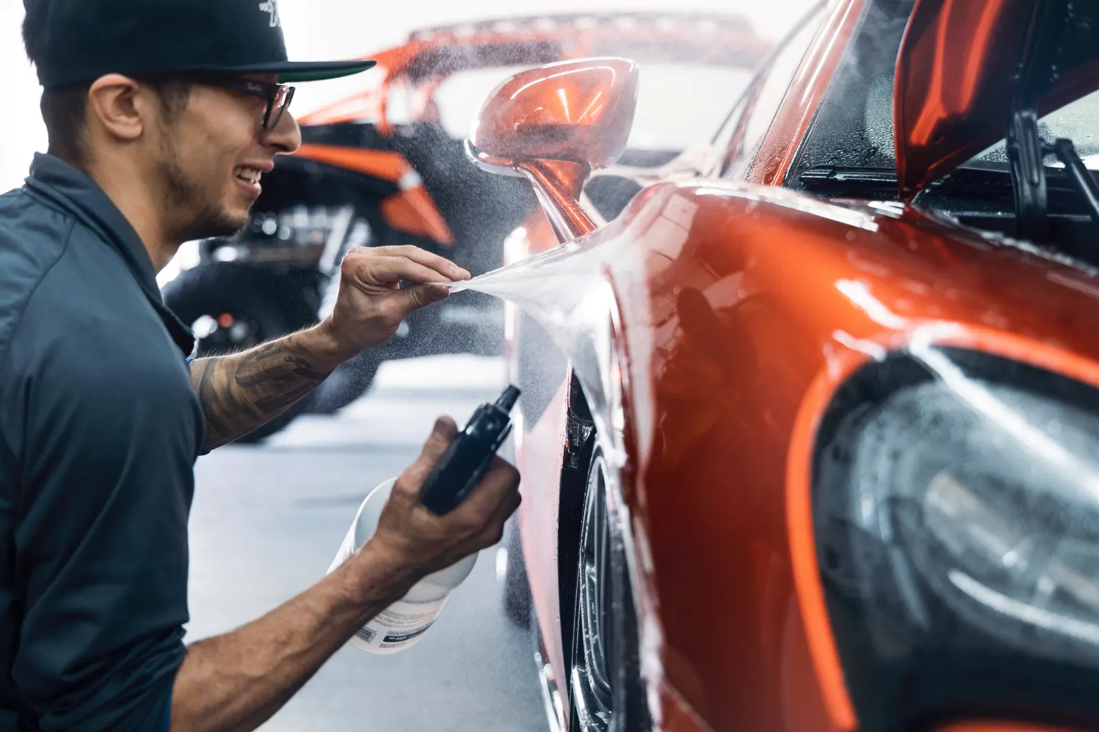 Car paint protection film being inspected in detailing studio
